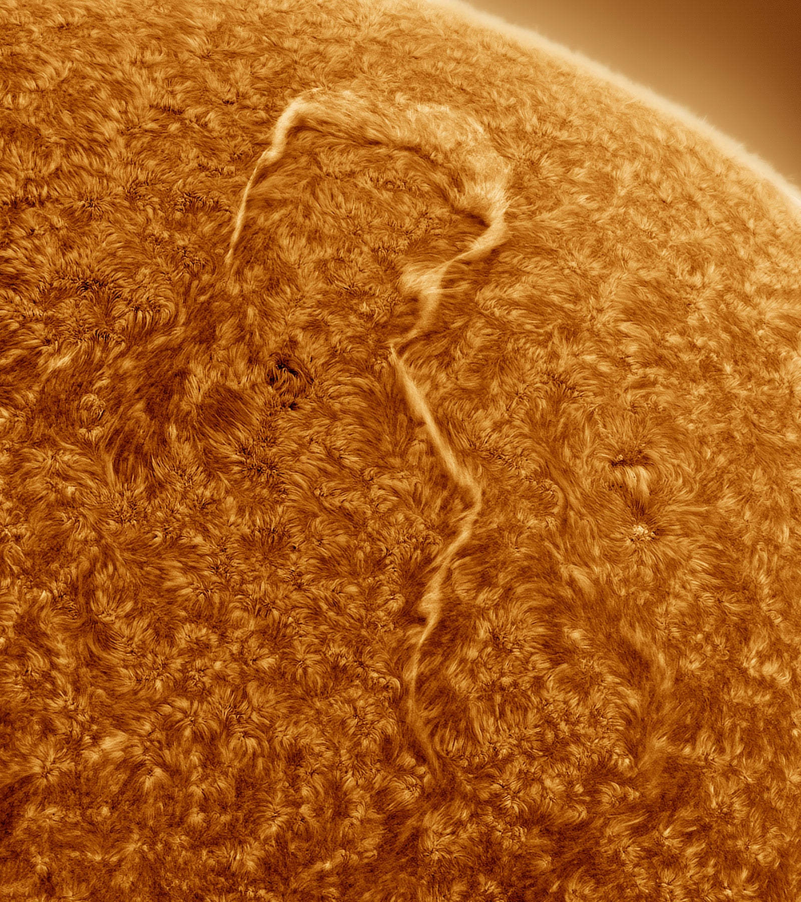 Un filamento que forma un arco a lo largo de la superficie del Sol.