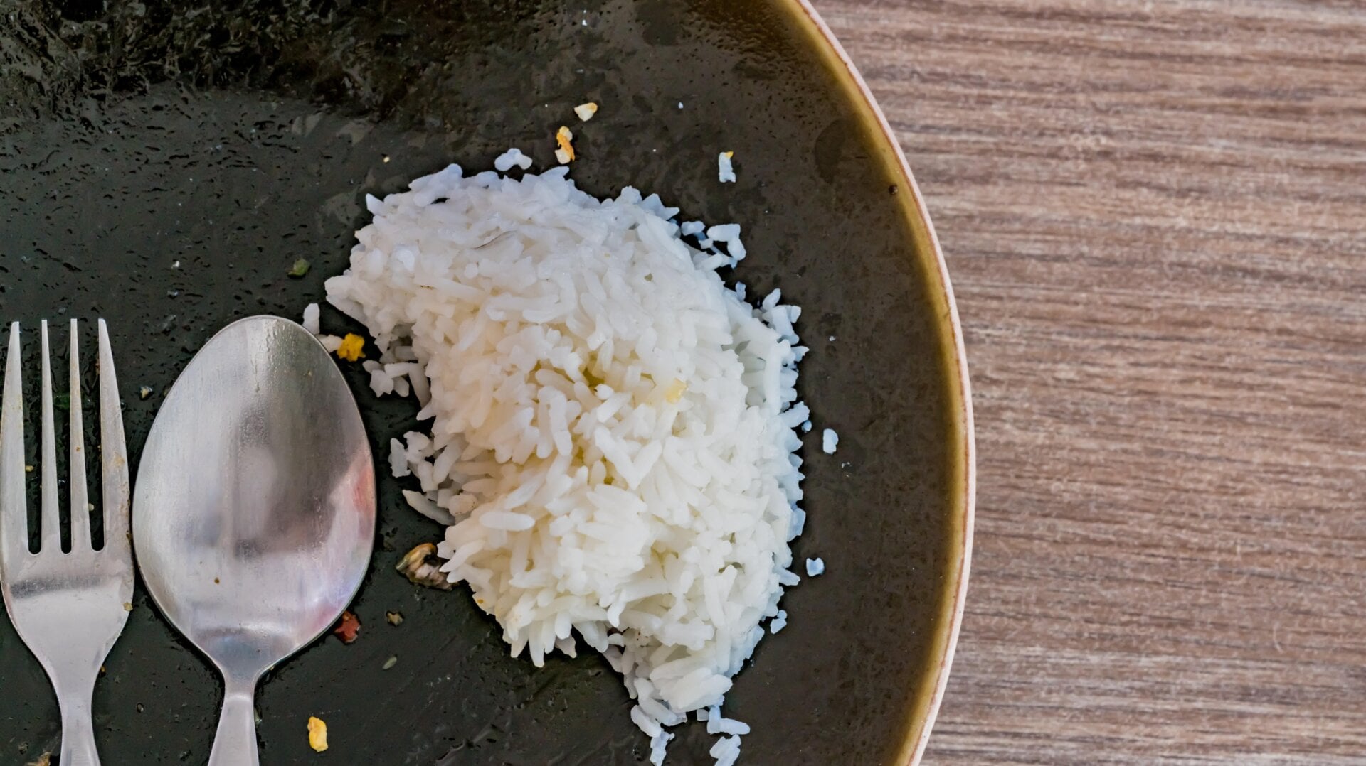 Sobras de arroz en un plato negro.