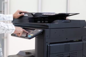 Bussinessman,press,button,on,panel,of,printer,photocopier,network,,