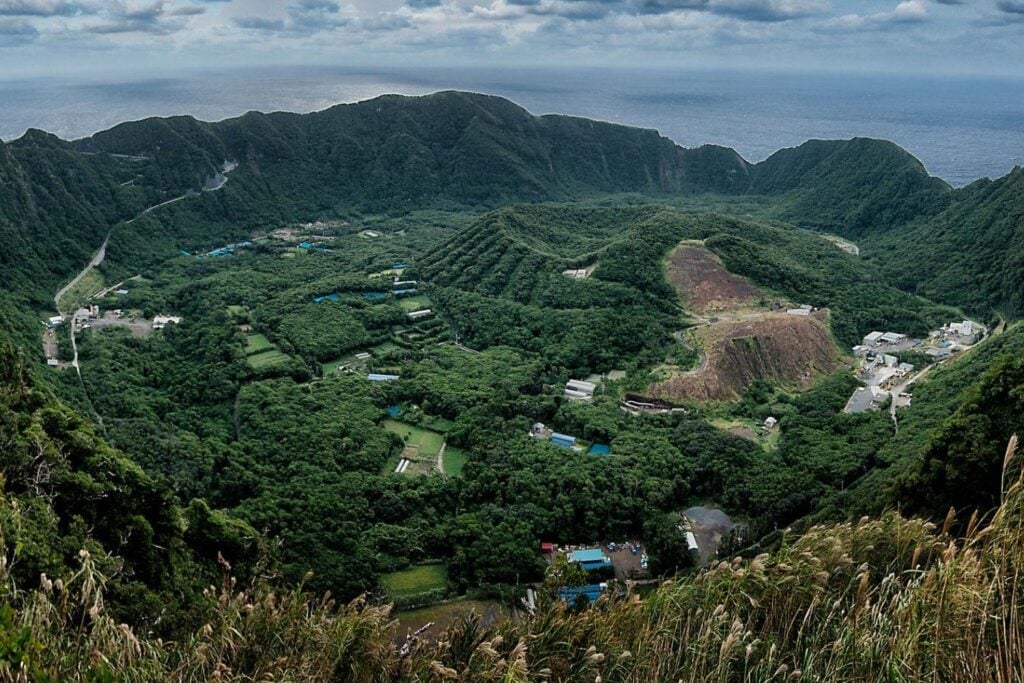 A 358 kilómetros de Tokio existe un pueblo de apenas 160 habitantes construido sobre un volcán activo. Sus vecinos cocinan con vapor geotérmico y dependen de un helicóptero o un ferry que el océano puede cancelar en cualquier momento