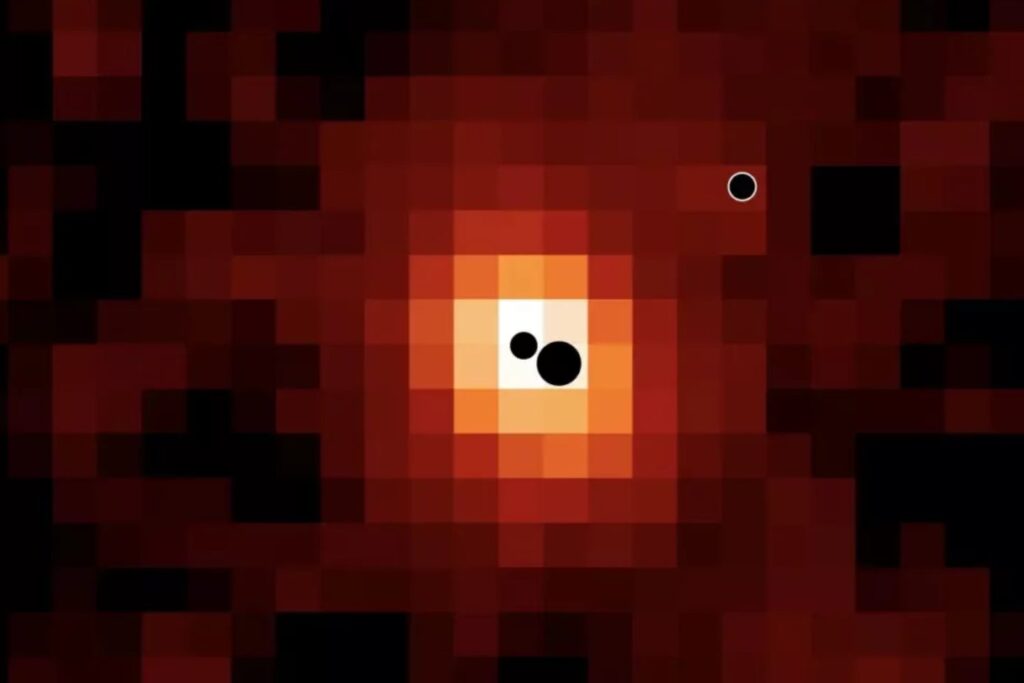 El James Webb encontró tres agujeros negros alimentándose en una galaxia a 12.500 millones de años luz. Dos ya avanzan hacia una colisión y el más pequeño crece por encima del límite teórico